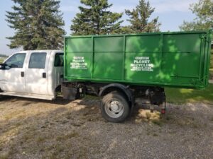 Green Planet Recycling truck with a green container