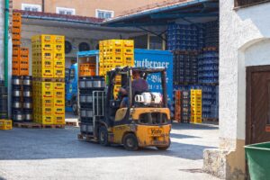 a forklift moving crates in a warehouse